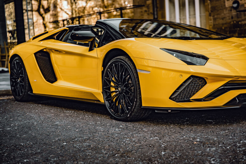 Yeloow Lamborghini Aventador parked on the side of the road