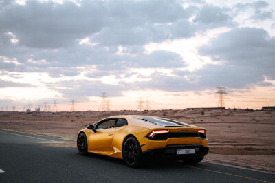 Lamborghini Huracán in yellow-orage on a desert road