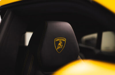 The Lamborghini logo embroidered on the headrest of seat in a Lamborghini Urus.