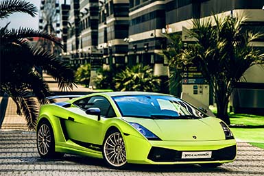 Lamborghini Gallardo parked in front of a luxury condo.