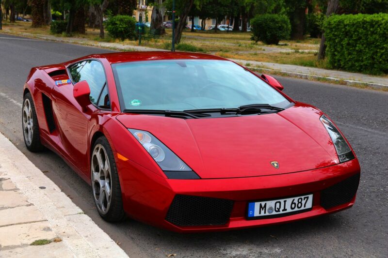 Red Lamborghini Gallardo parked on the street.