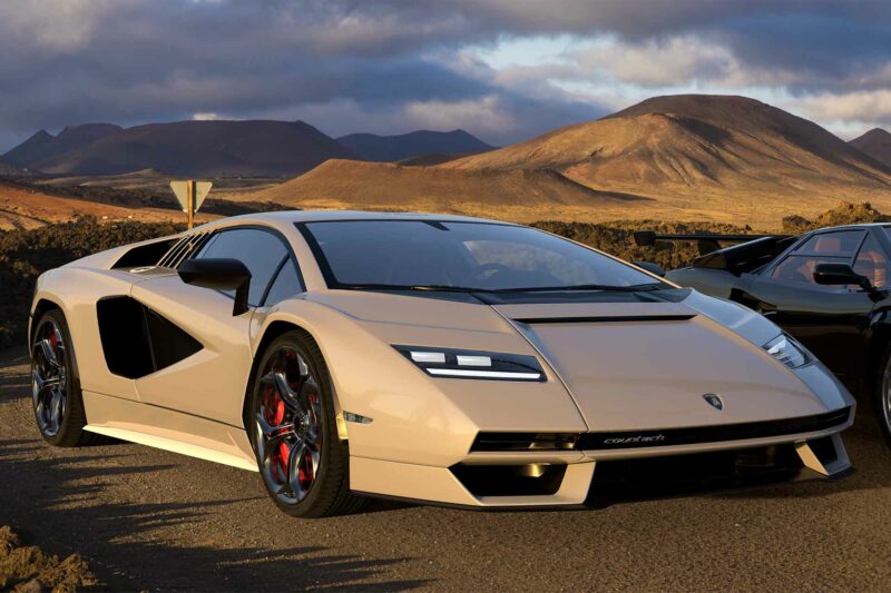 Lamborghini LPI 800-4 oarked on a desert road beside the original Lamborghini Countach