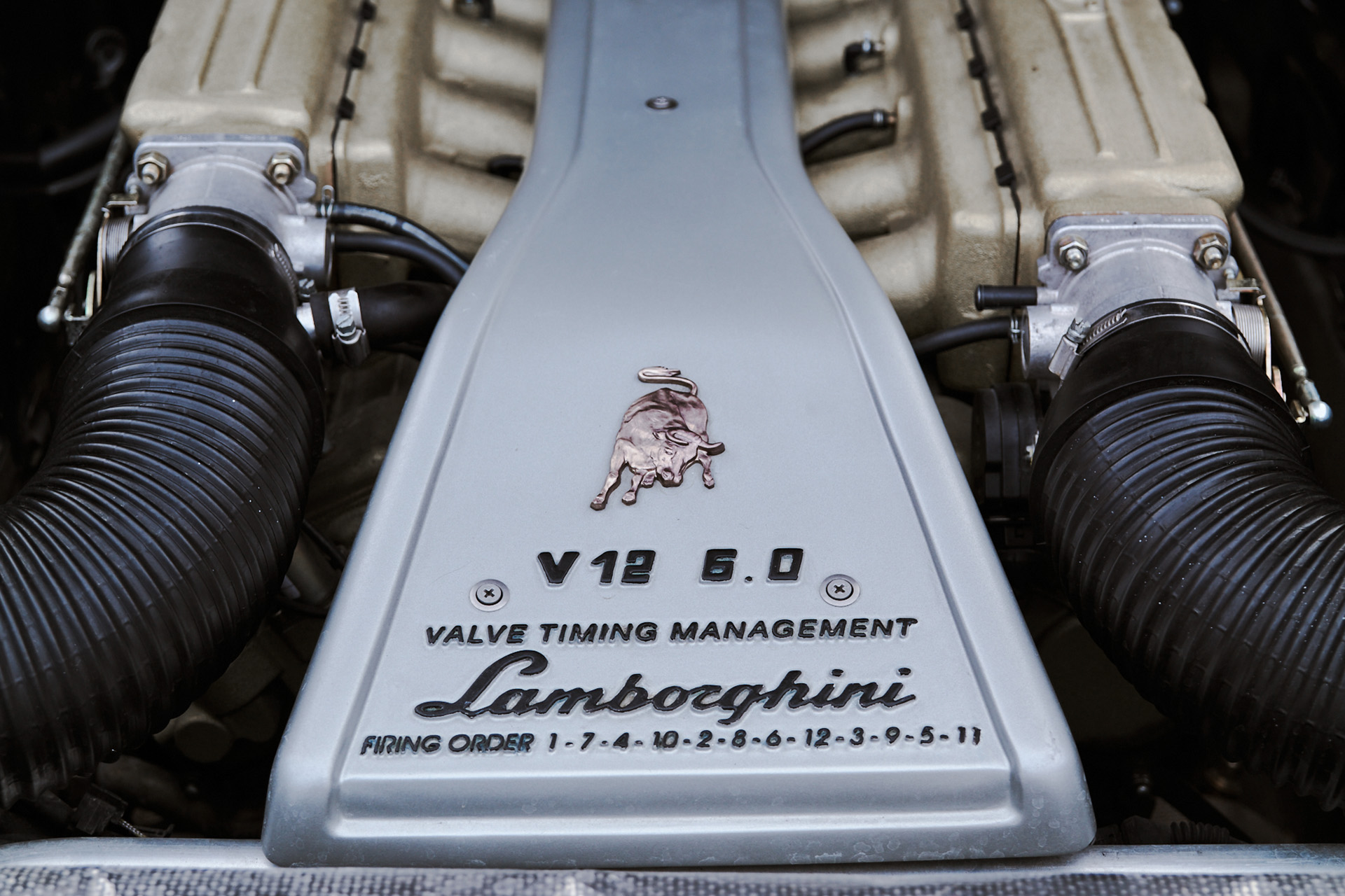 The engine of a Lamborghini Diablo, intake throttle body and plenum.