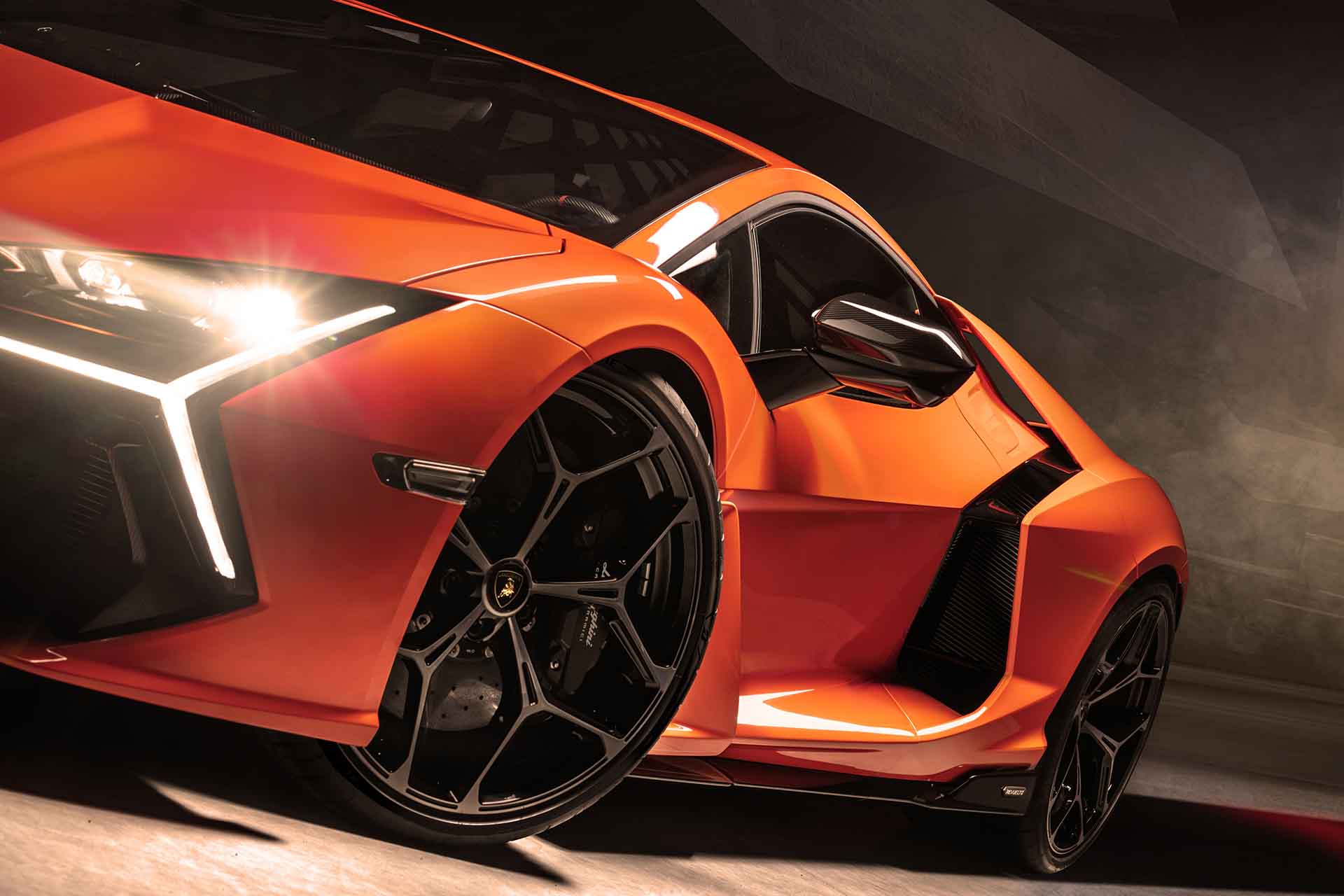 Photo of the flying buttress of an orange Lamborghini Revuelto supercar.