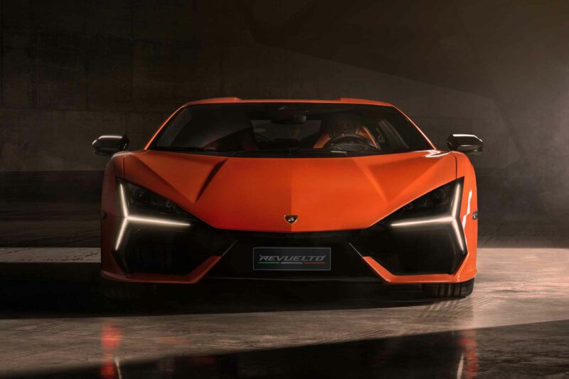 Orange Lamborghini Revuelto supercar front view with sunlight coming in the sides.