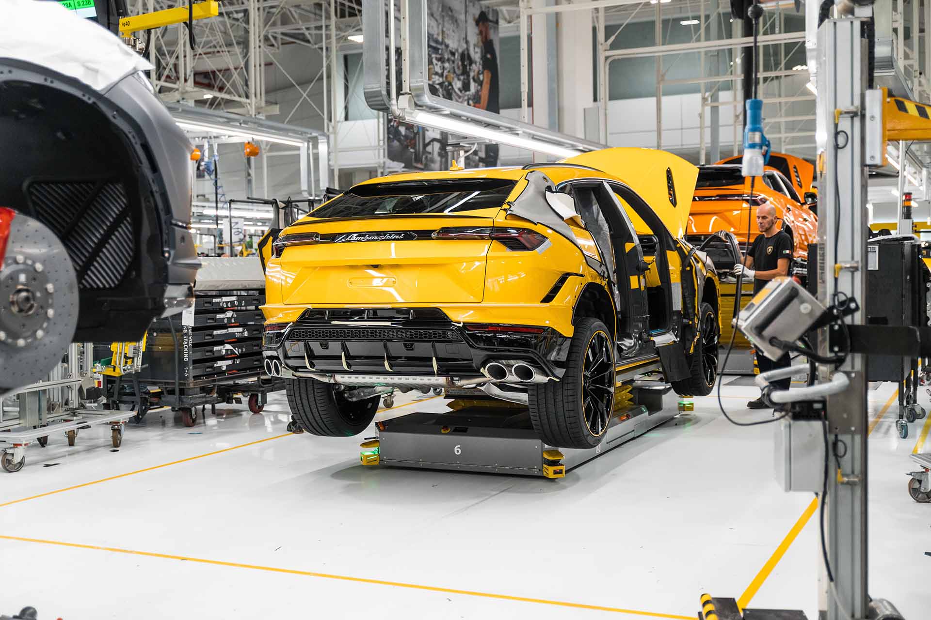 Yellow Lamborghini Urus being worked on at the factory.