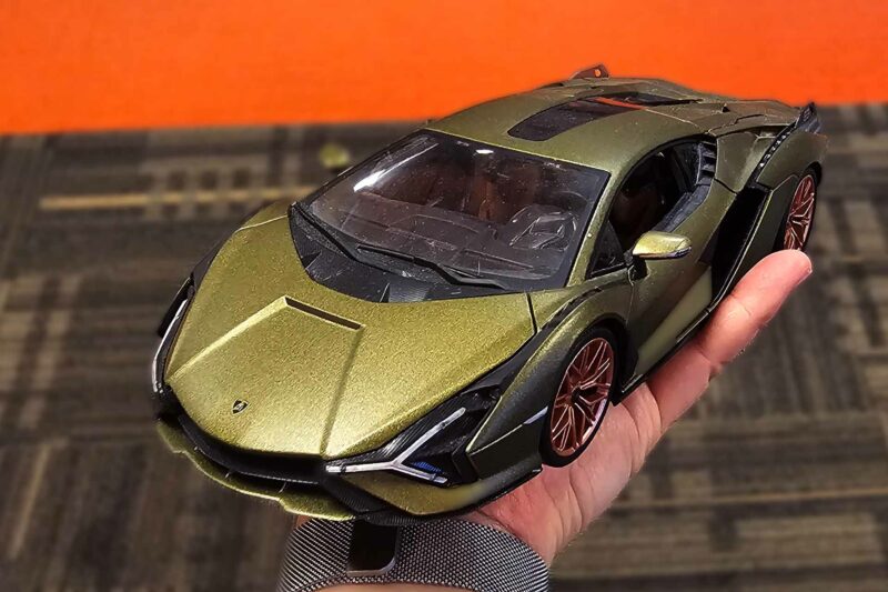 Lamborghini Sian model in a hand, painted in green