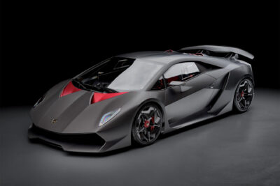 Grey and red Lamborghini Sesto Elemento with exposed carbon fibre. Front and side view. In a photo studio.
