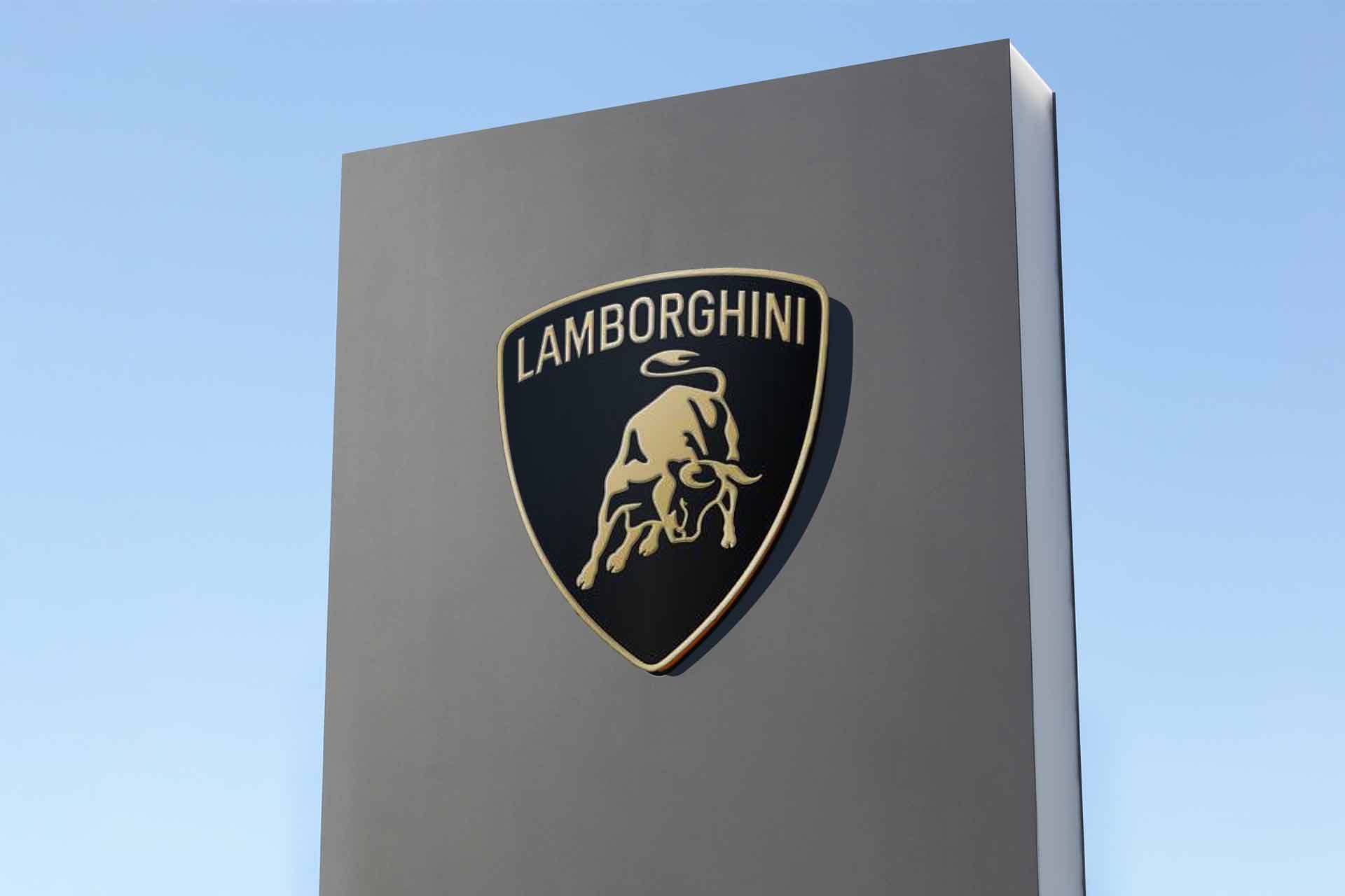 New Lamborghini logo on a chiron which would be in front of a Lamborghini dealership. Blue sky in the background.
