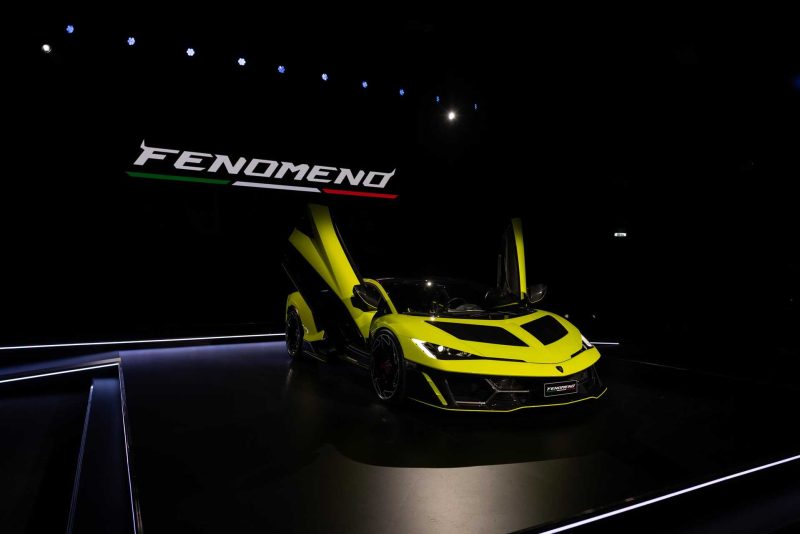 Photo of yellow Lamborghini Femoneno on stage, front quarted view with the doors open and up.